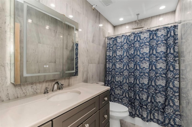 bathroom with vanity, tile walls, toilet, and a shower with shower curtain