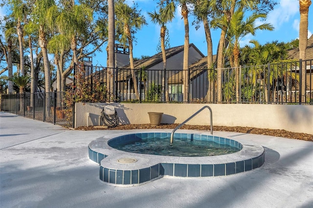 view of swimming pool with a hot tub