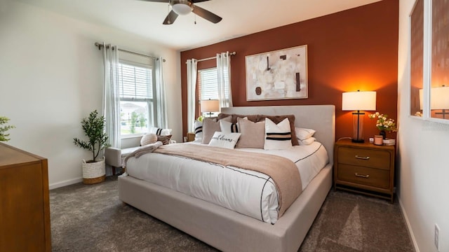 bedroom with ceiling fan and dark colored carpet