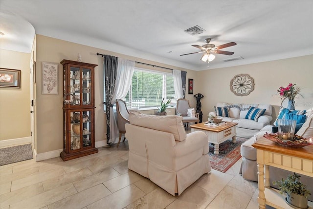 tiled living room featuring ceiling fan