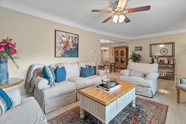 living room featuring ceiling fan with notable chandelier