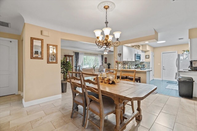 dining space featuring an inviting chandelier