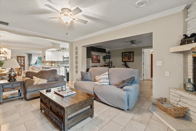 living room featuring crown molding, ceiling fan with notable chandelier, and a textured ceiling