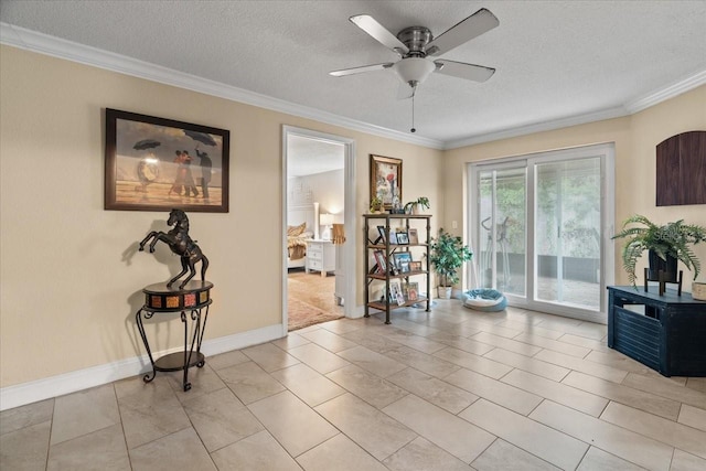 interior space with ceiling fan, ornamental molding, a textured ceiling, and light tile patterned flooring