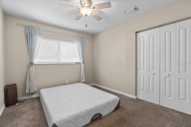 carpeted bedroom featuring ceiling fan and a closet