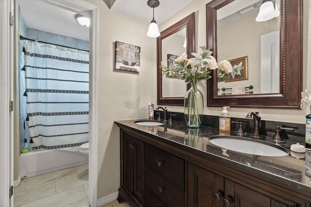 full bathroom featuring vanity, shower / tub combo with curtain, and toilet