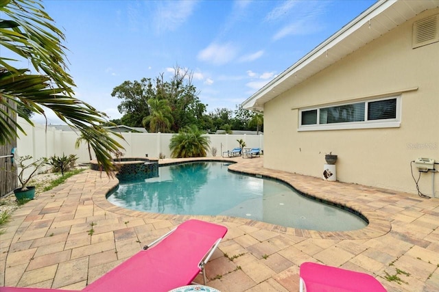 view of swimming pool with an in ground hot tub and a patio