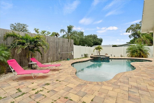 view of pool featuring a patio and an in ground hot tub