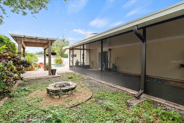 view of yard with a patio, a pergola, and an outdoor fire pit