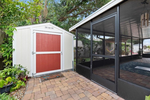 view of outdoor structure with a sunroom