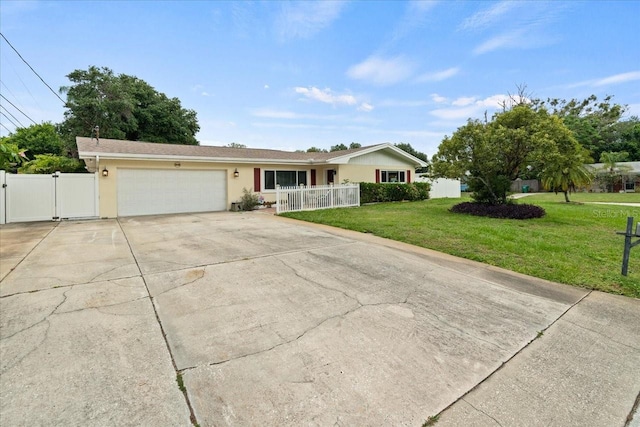 ranch-style house featuring a garage and a front lawn