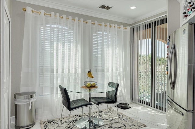 dining room featuring visible vents and ornamental molding