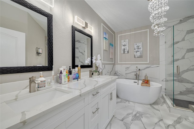 full bath featuring a marble finish shower, marble finish floor, a freestanding tub, and a sink