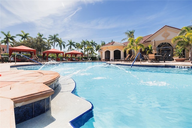 pool with a gazebo and a patio area