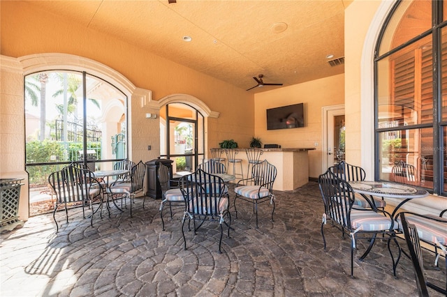 view of patio / terrace featuring outdoor dry bar and visible vents