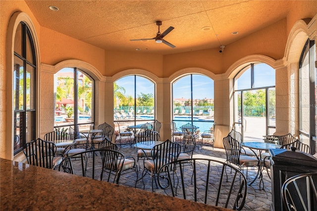 interior space with ceiling fan