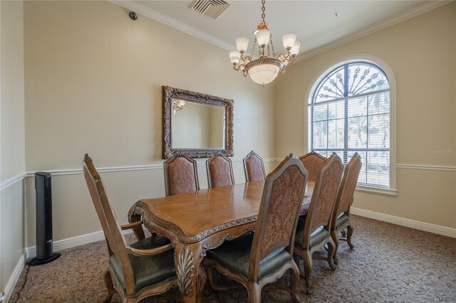 carpeted dining room with visible vents, baseboards, a notable chandelier, and crown molding