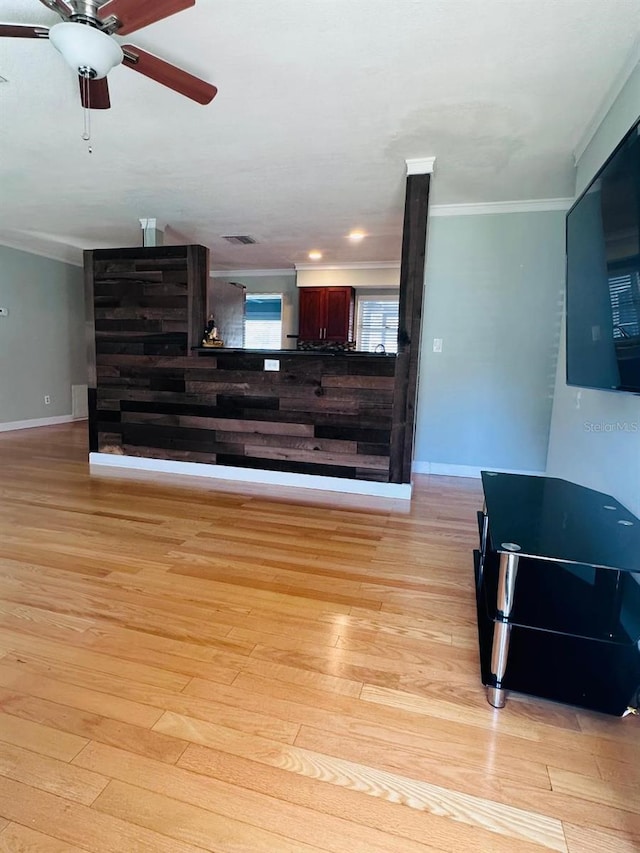 interior space featuring ornamental molding, ceiling fan, and light hardwood / wood-style floors