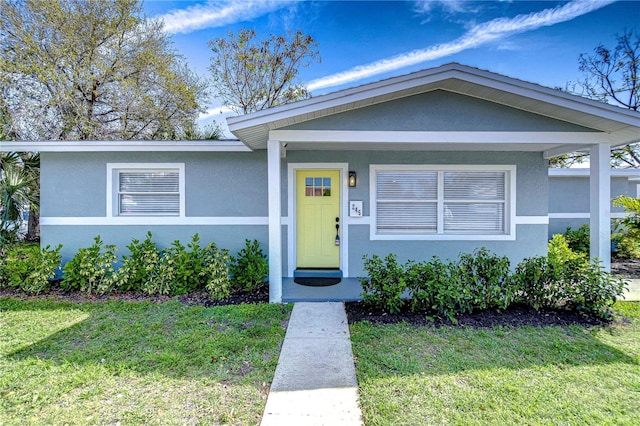 view of front of house featuring a front yard and stucco siding