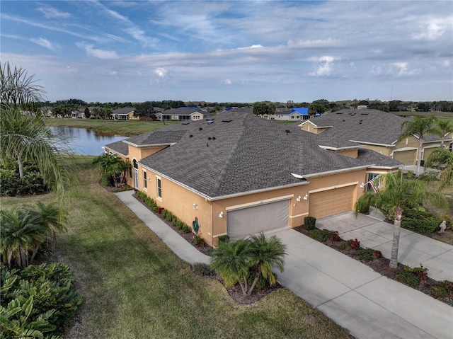 bird's eye view featuring a residential view and a water view