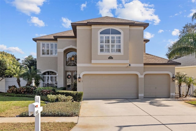 view of front of property with concrete driveway and stucco siding