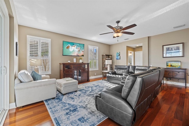 1881 Riveredge Dr, Tarpon Springs, FL 34689 - living area with dark wood finished floors, baseboards, and a ceiling fan