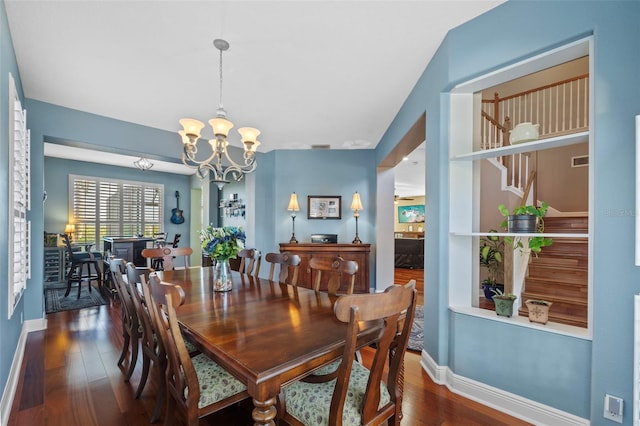 1881 Riveredge Dr, Tarpon Springs, FL 34689 - dining room with a chandelier, wood finished floors, and baseboards