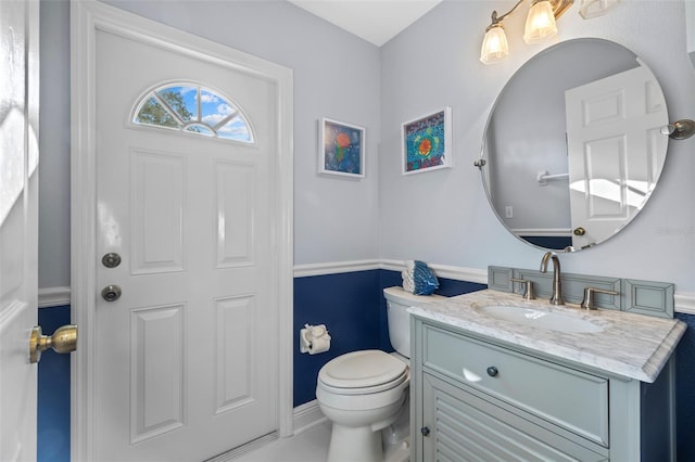 1881 Riveredge Dr, Tarpon Springs, FL 34689 - half bathroom featuring toilet, vanity, and baseboards