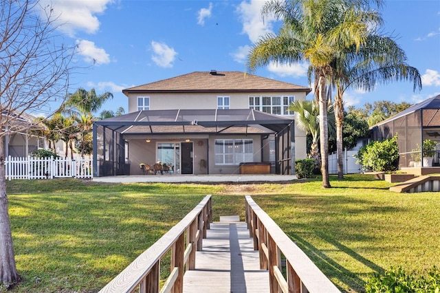 1881 Riveredge Dr, Tarpon Springs, FL 34689 - back of property featuring stucco siding, glass enclosure, and a patio