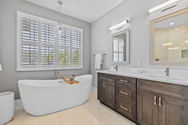 1881 Riveredge Dr, Tarpon Springs, FL 34689 - bathroom with a freestanding tub, baseboards, double vanity, tile patterned flooring, and a shower