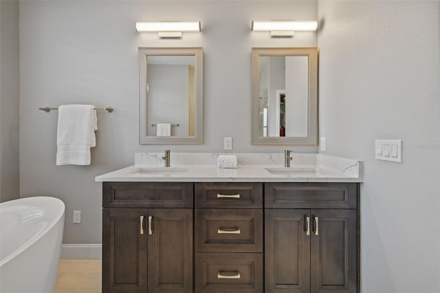 1881 Riveredge Dr, Tarpon Springs, FL 34689 - full bathroom with double vanity, a freestanding bath, and baseboards