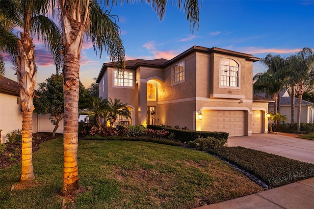 1881 Riveredge Dr, Tarpon Springs, FL 34689 - mediterranean / spanish home with stucco siding, a garage, driveway, and a front yard