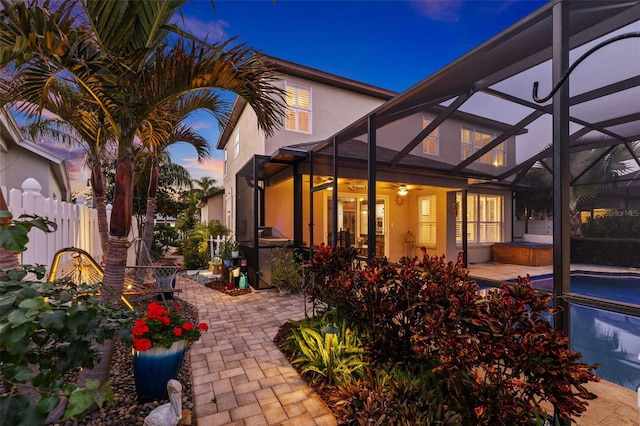 1881 Riveredge Dr, Tarpon Springs, FL 34689 - back of property featuring stucco siding, a lanai, a patio area, and fence