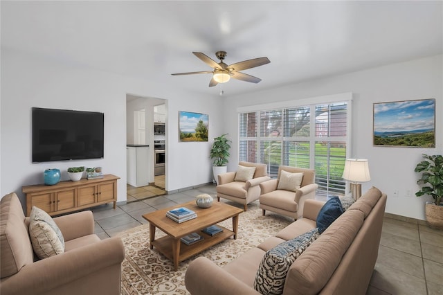 living room featuring ceiling fan and light tile patterned floors