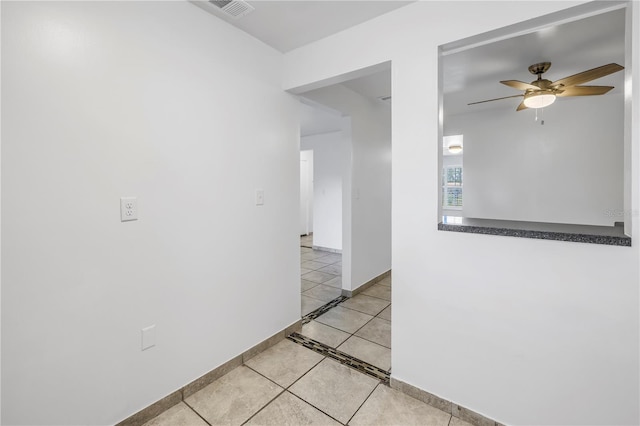 hall with light tile patterned floors