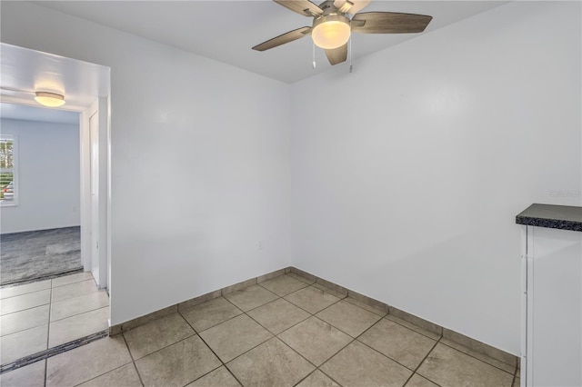 tiled empty room with ceiling fan