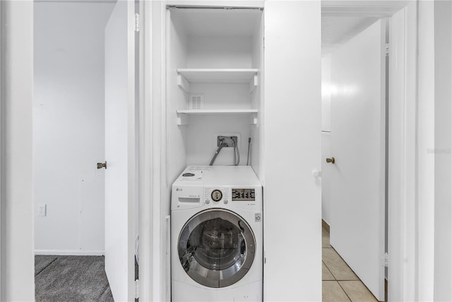 laundry room featuring washer / clothes dryer and light tile patterned flooring