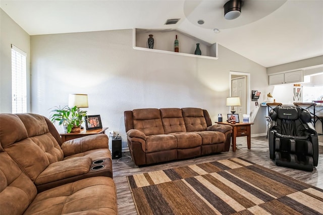 living room with lofted ceiling and ceiling fan