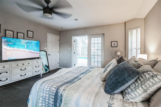 bedroom with ceiling fan, dark carpet, and access to outside