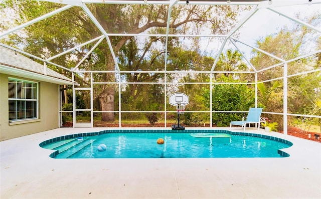 view of swimming pool featuring a lanai and a patio area