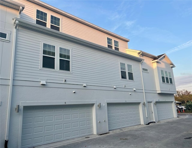 back of house featuring a garage