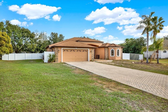 view of front of property featuring a garage and a front lawn