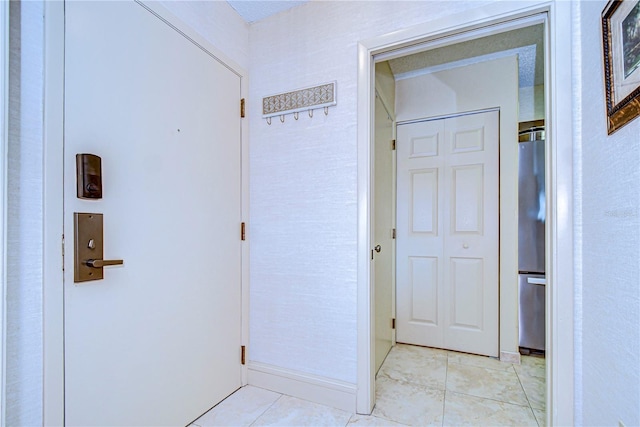 corridor with light tile patterned floors