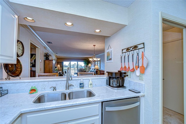 kitchen with sink, stainless steel dishwasher, a chandelier, and white cabinets