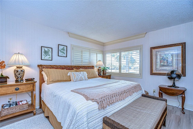 bedroom with hardwood / wood-style floors and a textured ceiling