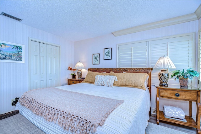 bedroom with a closet and a textured ceiling