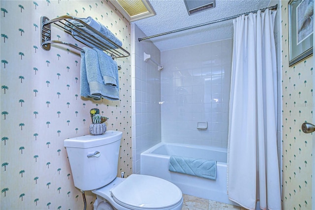 bathroom with a textured ceiling, shower / bath combo, and toilet