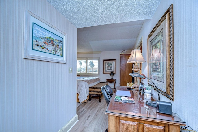 office with a textured ceiling and light hardwood / wood-style flooring