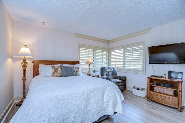 bedroom with wood-type flooring and a textured ceiling