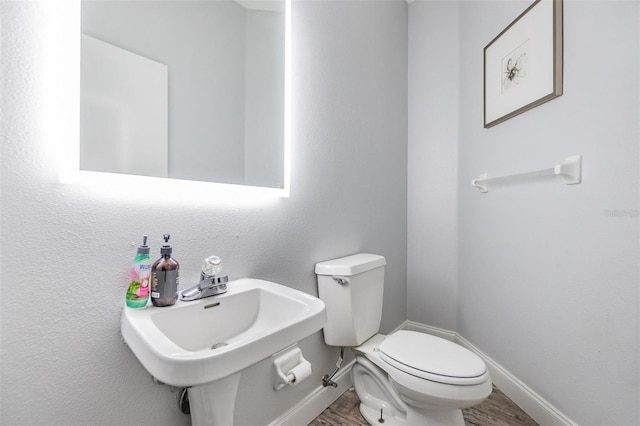 bathroom featuring sink, hardwood / wood-style floors, and toilet